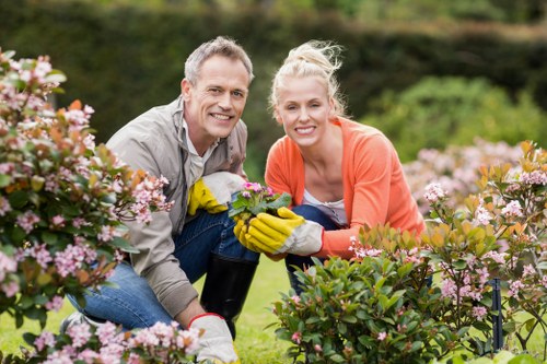 Outdoor crew managing tools and waste safely during a landscaping job